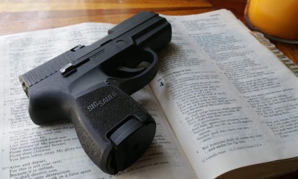 Holy Bible and SIG SAUER handgun (courtesy youtube.com)
