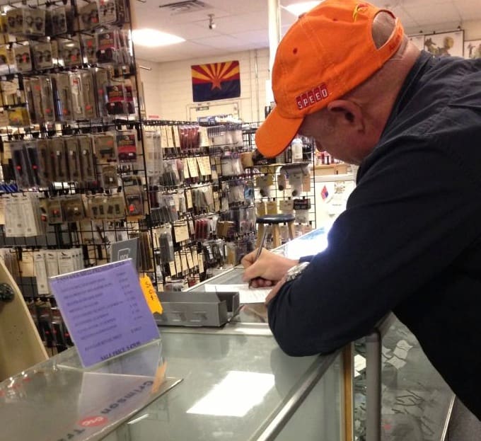 Mark Kelly filling out his paperwork for an AR15 (courtesy facebook)