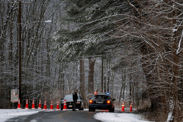 Police block the road to Sandy Hook Elementary School in Newtown, Conn., on Dec. 25, 2012. (Craig Ruttle/AP)