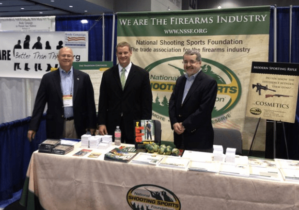 Representatives of the Newtown-based National Shooting Sports Foundation stand in their booth at the National Conference of State Legislatures in Chicago in August. From left, Lawrence G. Keane, NSSF senior vice president and general counsel; Jake McGuigan, NSSF director of government relations – state affairs; and Mike Bazinet, NSSF director of public affairs. (www.nssf.org)