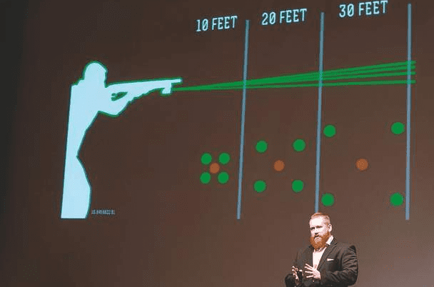 "Sam Lambert, CEO and founder of the Prineville-based Ochoco Arms, describes his multilaser-sighting system at the Bend Venture Conference on Oct. 18. Lambert's idea garnered a $10,000 prize in the concept-stage division of the competition." (courtesy bendbulletin.com)