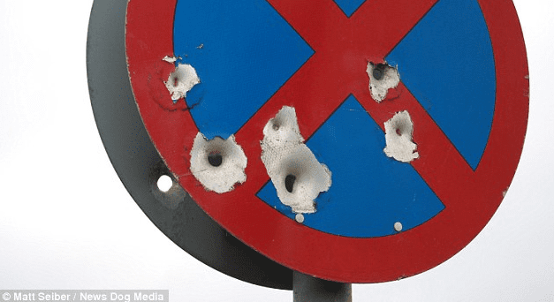 "Sinister- This No Stopping sign near the A40 in Oxfordshire is riddled with what appear to be bullet-holes." (caption courtesy dailymail.co.uk, photo courtesy Matt Seiber/News Dog Media)