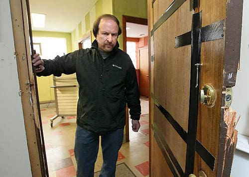 Landlord David Salkin inspects property damage caused by undercover ATF sting, without compensation (courtesy tracesofreality.com)