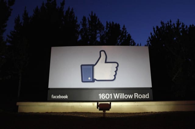 File photo of the sun rising behind the entrance sign to Facebook headquarters in Menlo Park