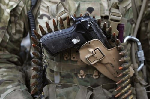 A pistol is seen holstered as a U.S. Army soldier from Charlie Company 4th Platoon, 1st Brigade 3-21 Infantry prepares to go on patrol in the Panjwai district of Kandahar province