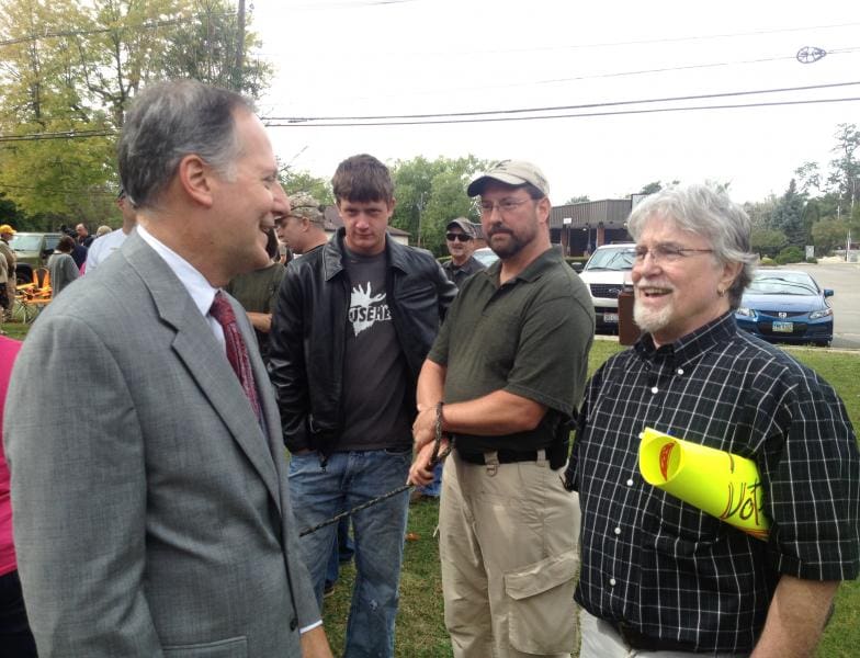 Reverend Dave Hill (left) and gun guy (courtesy wksu.org)