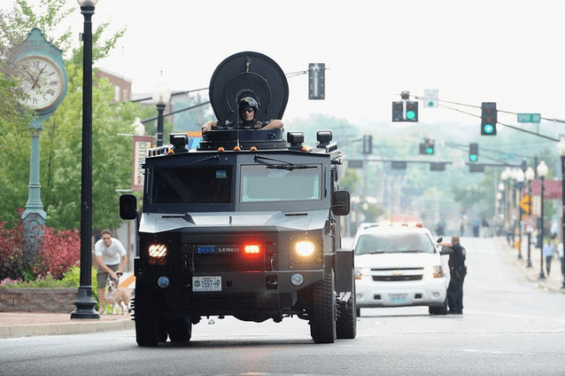 "A Missouri State Highway Patrol tactical vehicle travels down South Florissant Road in Ferguson on Monday. " (text and photo courtesy mashable.com)