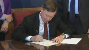 Colorado Governor John Hickenlooper signs new gun laws (courtesy cbsdenver.com)