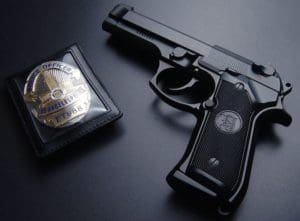 LA cop badge and gun (courtesy xdesktopwallpapers.com)