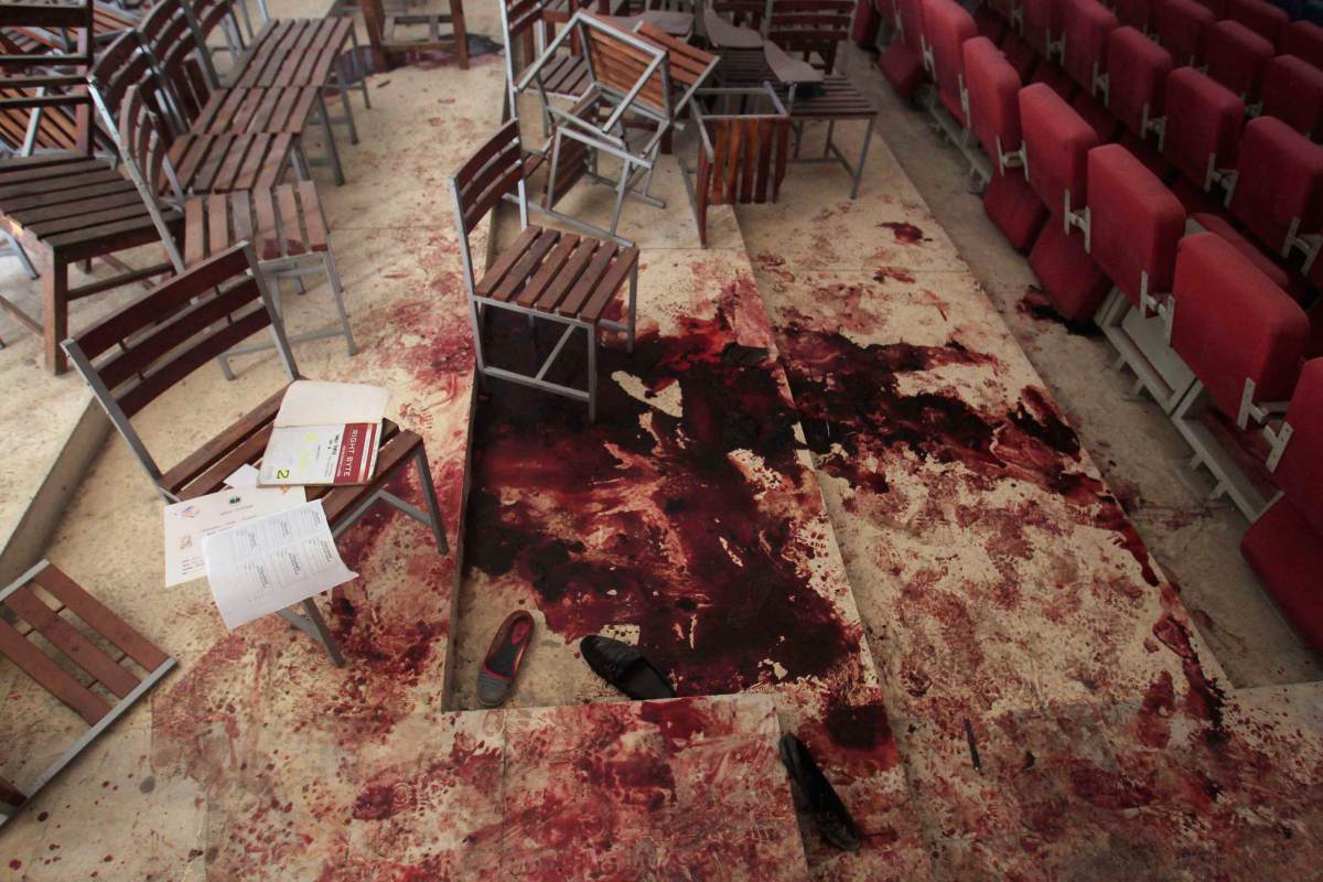 Shoes lie in blood on the auditorium floor at the Army Public School, which was attacked by Taliban gunmen, in Peshawar