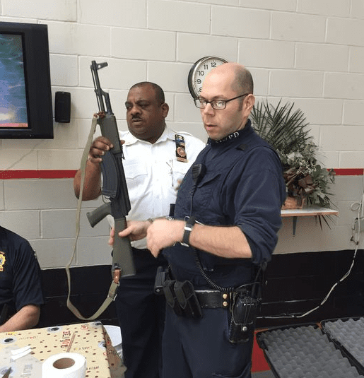 "Mount Vernon police Lt. Richton Ziadie, left, and Officer John Damiano accept an assault rifle at a gun buyback program in Mount Vernon on Saturday." (caption and photo courtesy lohud.com)