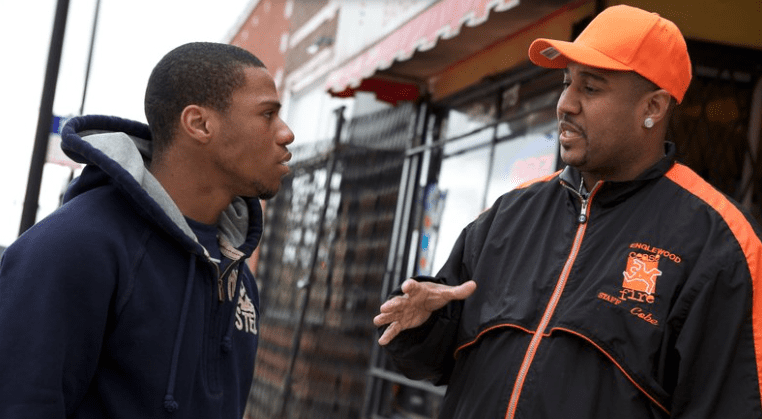"Ricardo "Cobe" Williams, wearing the cap, served time for attempted murder before joining CeaseFire as a "violence interrupter." Above, he talks with Lil Mikey in a scene from the documentary The Interrupters."" (photo and caption courtesy npr.org)