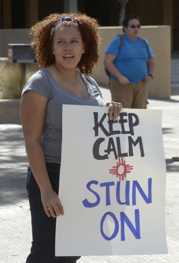 "UNM student Tera Archie holds a sign during a petition drive to reverse the ban on stun guns and pepper spray on campus, photographed on Monday February 29, 2016." (text and photo courtesy Dean Hanson/Albuquerque Journal)