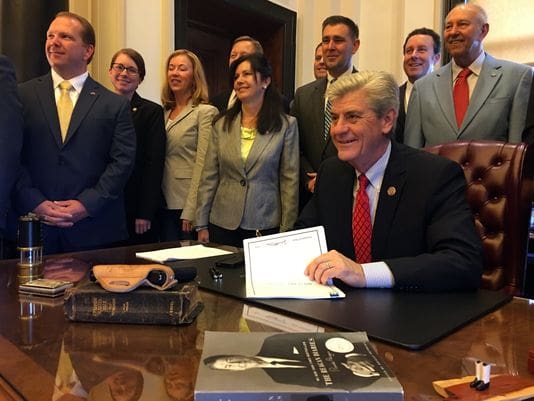Mississippi Governor Bryant sign Church Protection Act (courtesy clarionledger.com)