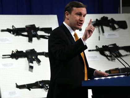 WASHINGTON, DC - JANUARY 24: U.S. Senator Chris Murphy (D-CT) speaks next to a display of assault weapons during a news conference January 24, 2013 on Capitol Hill in Washington, DC. U.S. Senator Dianne Feinstein (D-CA) announced that she will introduce a bill to ban assault weapons and high-capacity magazines capable of holding more than 10 rounds to help to stop gun violence. (Photo by Alex Wong/Getty Images)