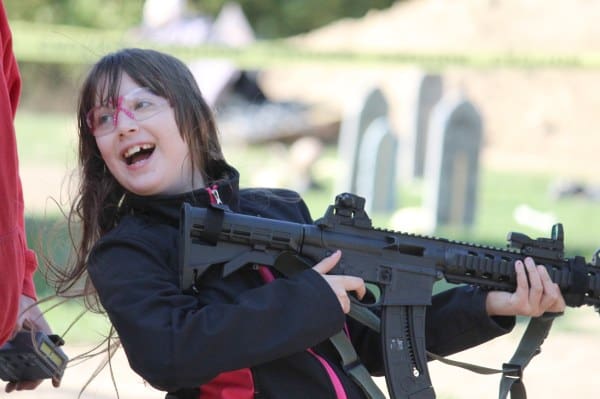 Yes, we know she has her finger on the trigger after firing her first semi-auto rifle at a "Zombie Shoot", this young lady was very excited. We corrected her finger on the trigger habit.