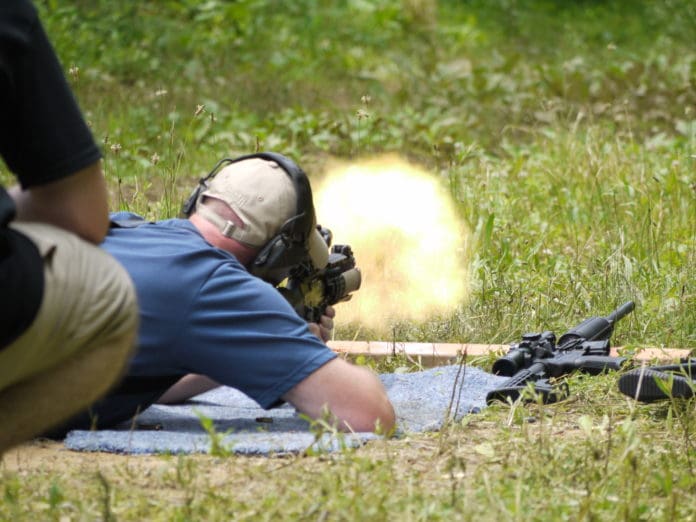 rifle shooter prone muzzle flash recoil