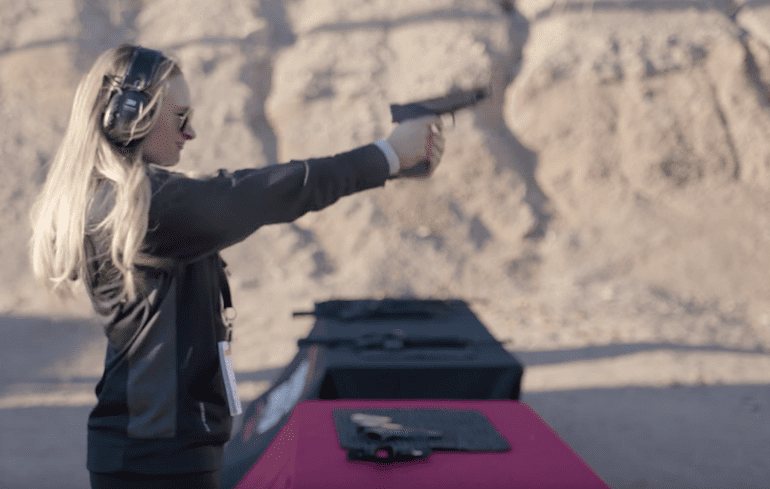 Female shooter shooting Springfield Mod 2 handgun, gripping the GRIP ZONE (courtesy youtube.com)