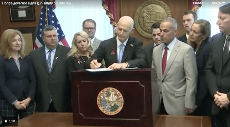 Florida Gov. Rick Scott signs gun control bill (courtesy washingtonpost.com)
