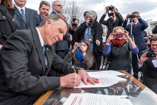 Vermont Governor Scott hears calls of betrayal and thanks as he signs gun bills