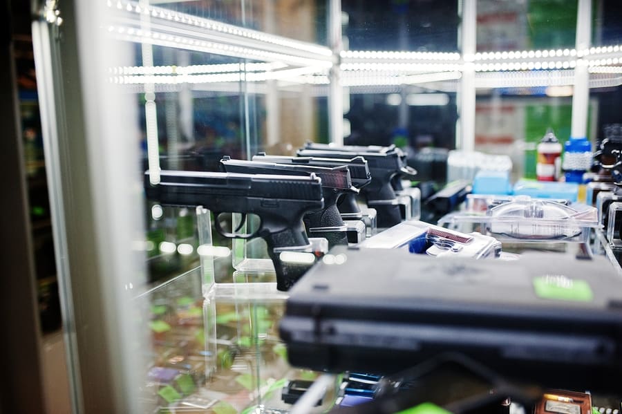 Different Guns And Revolvers On Shelves Gun Store Weapons On Shop