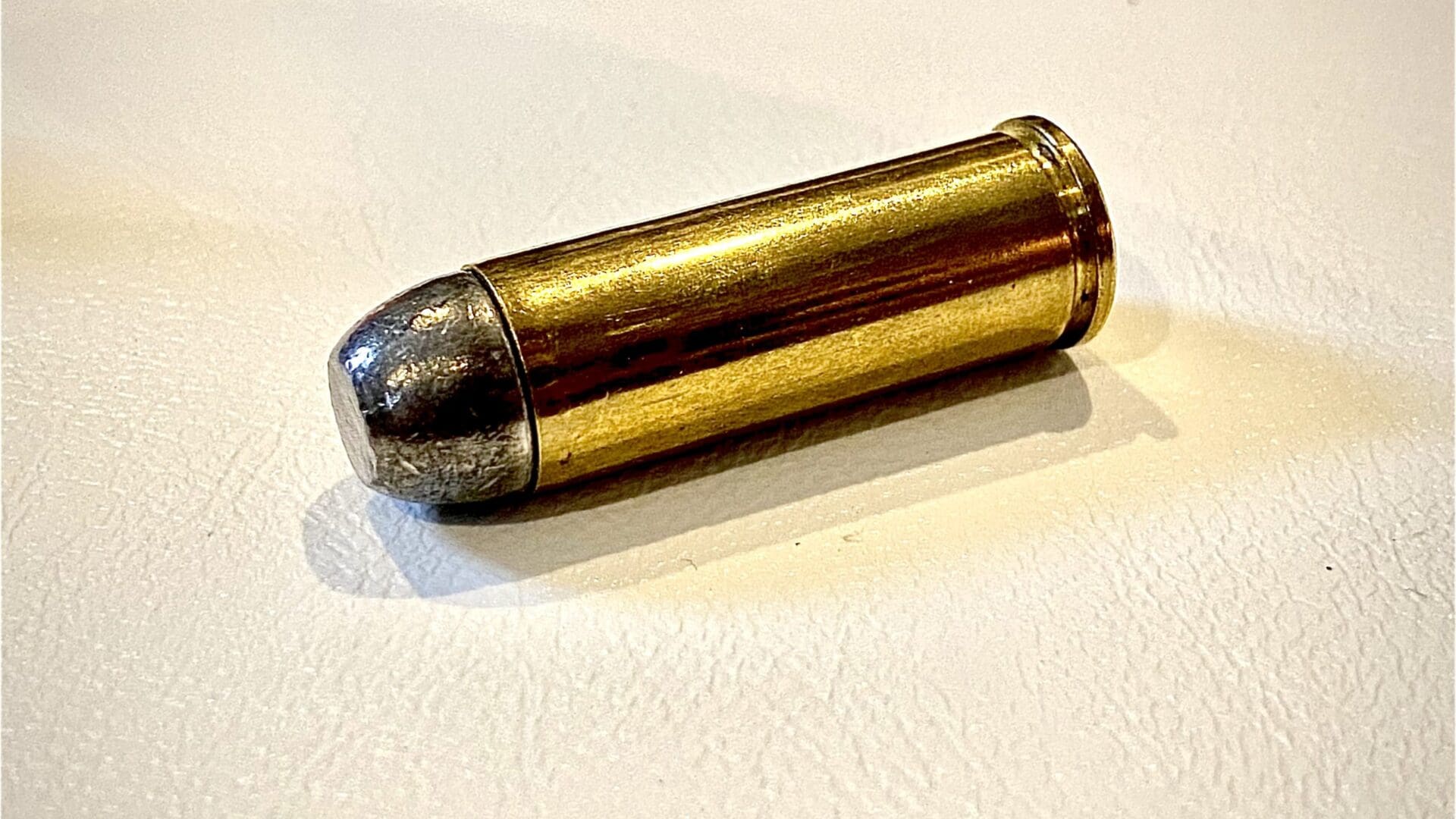 Opened Brass Colored Bullet Showing The Black Gun Powder Stock