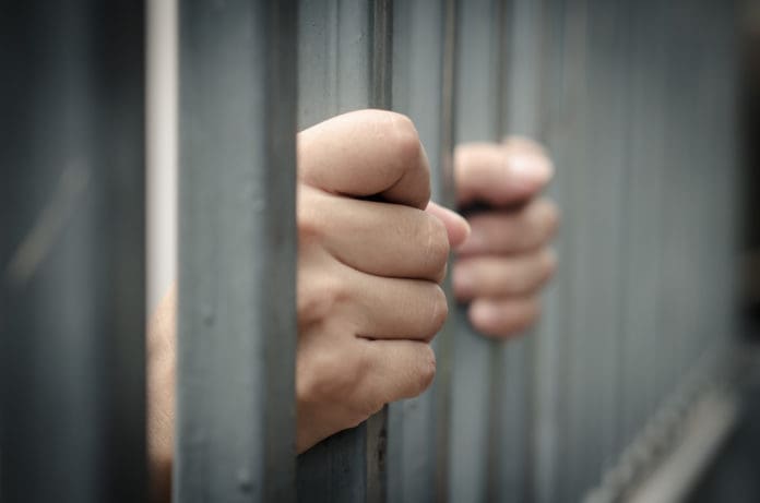 jail bars hands prison