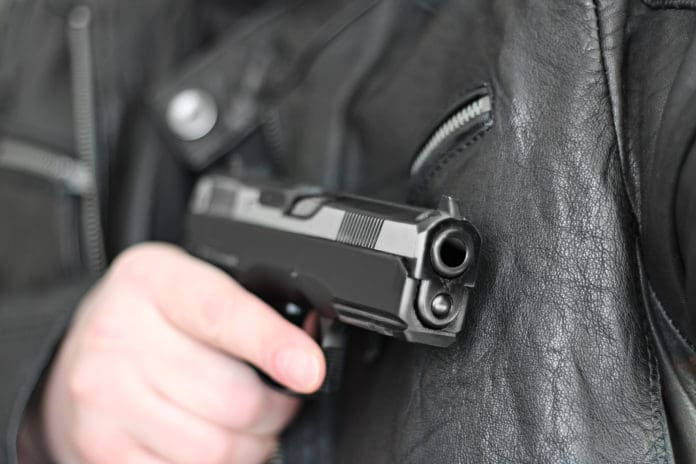 man with pistol concealed robber mugger armed