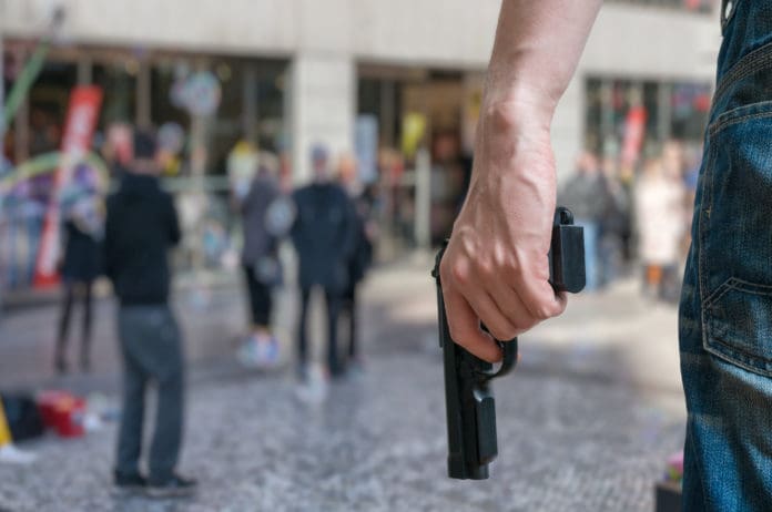 Armed,Man,(attacker),Holds,Pistol,In,Public,Place.,Many,People
