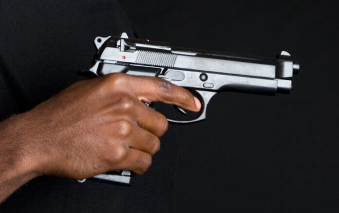 black man hand gun