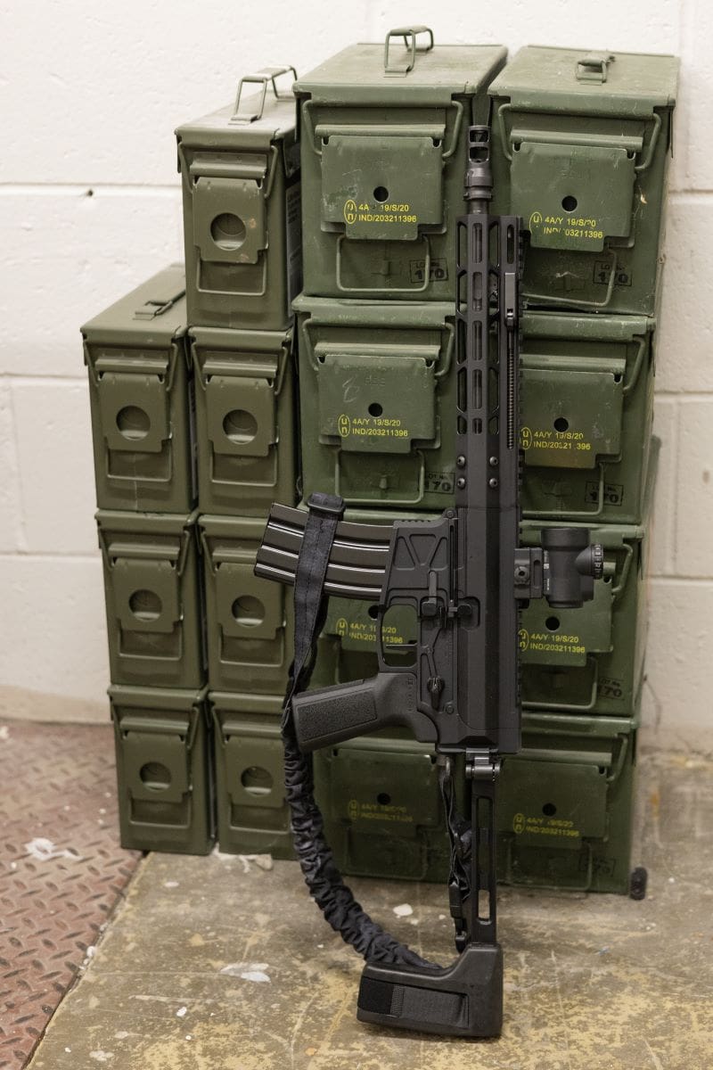 RIfle leaning green containers