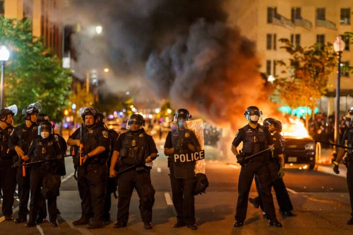 Police stand against a riot in the United States. BLM